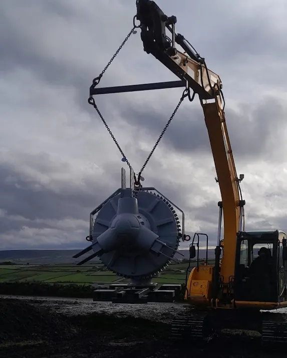 An excavator lifting a KW30 nacelle into place during the installation