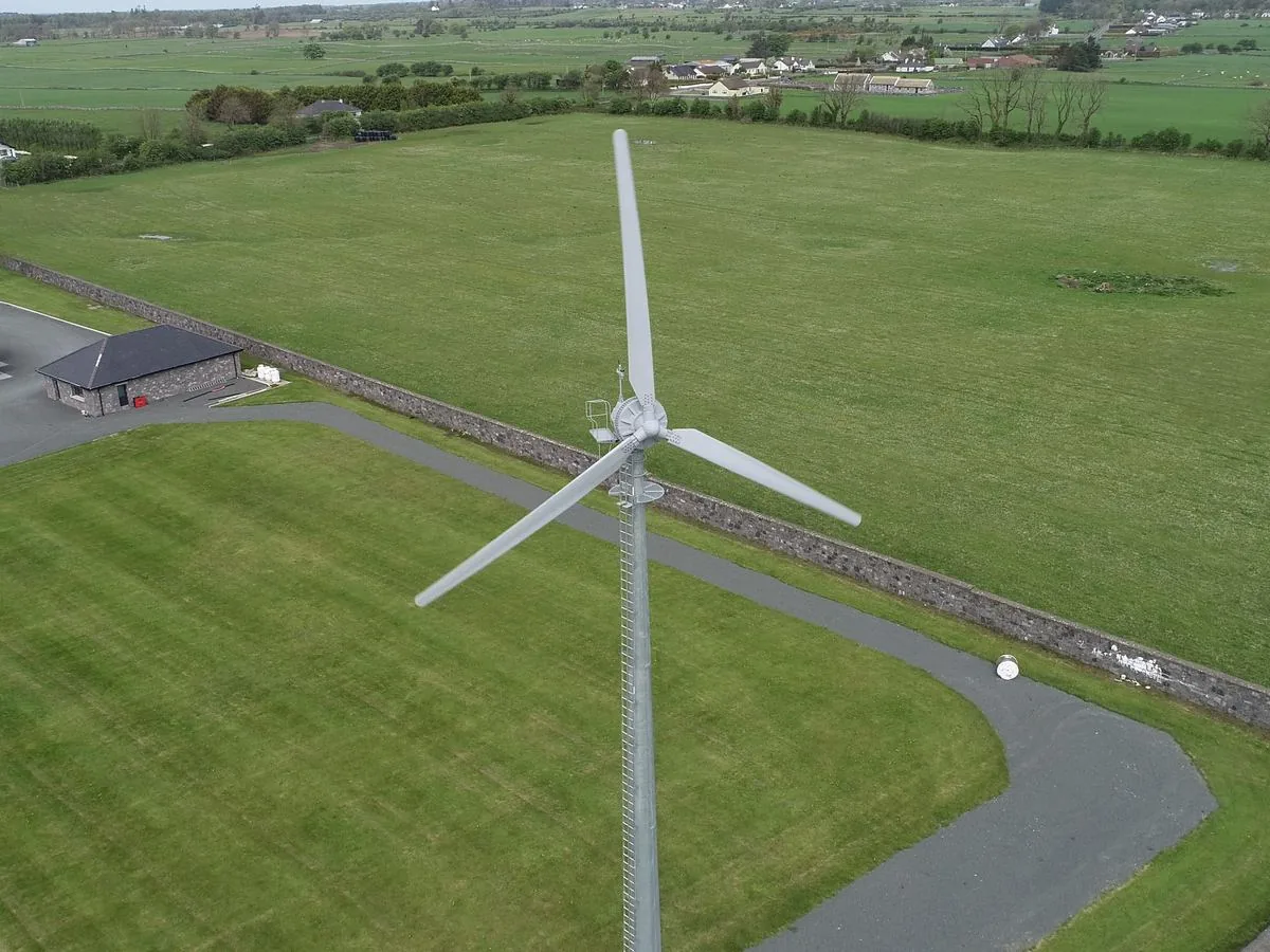 Aerial view of a Kodair turbine running beside farm buildings
