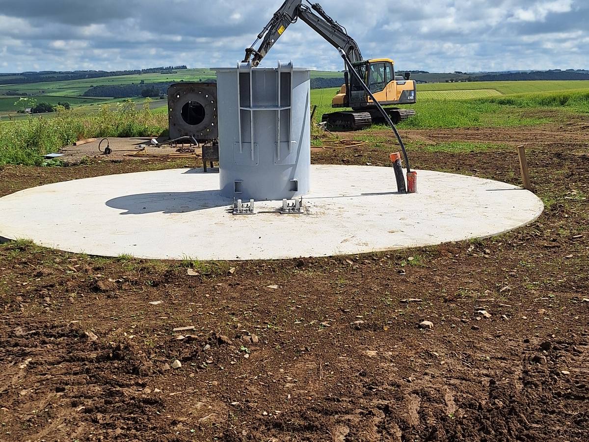 A finished circular concrete foundation with the tower base set in the centre
