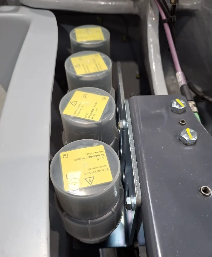 Four lubricant cartridges of the automatic lubrication system